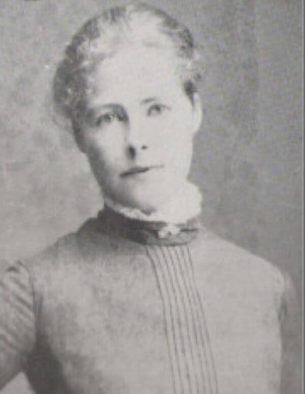 Black and white portrait of a woman in vintage attire.
