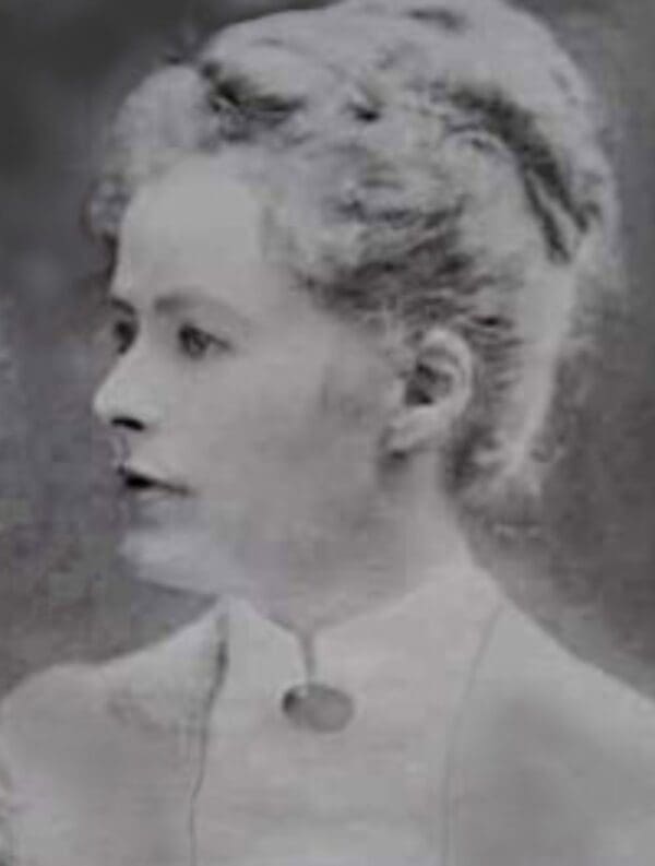 Black and white portrait of a woman in vintage attire.