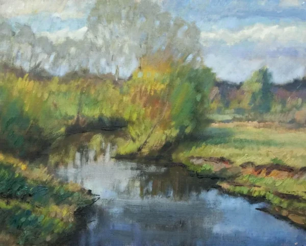 A serene river flowing through a lush green landscape under a cloudy sky.