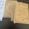 Handmade seed packets labeled with plant names and instructions.