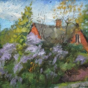 Quaint house surrounded by blooming lilacs.