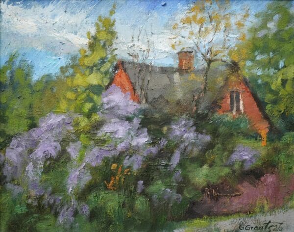Quaint house surrounded by blooming lilacs.