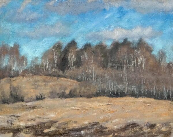 A serene landscape with trees and a cloudy blue sky.