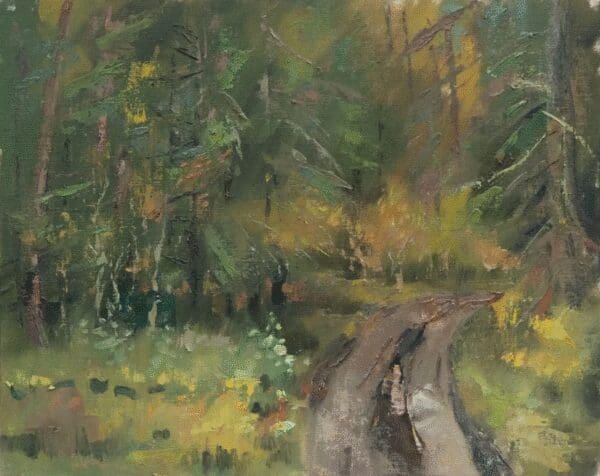 A winding dirt path through a dense, green forest.