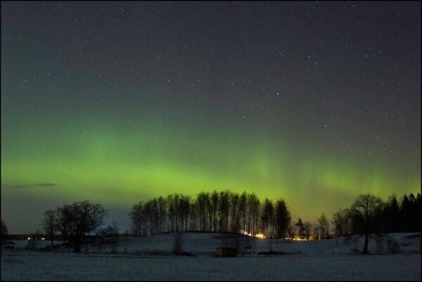 Northern lights over a snowy landscape