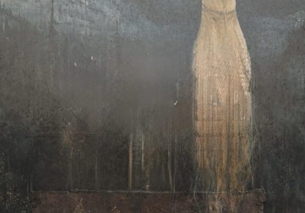 A solitary figure wrapped in cloth stands against a dark, textured background.